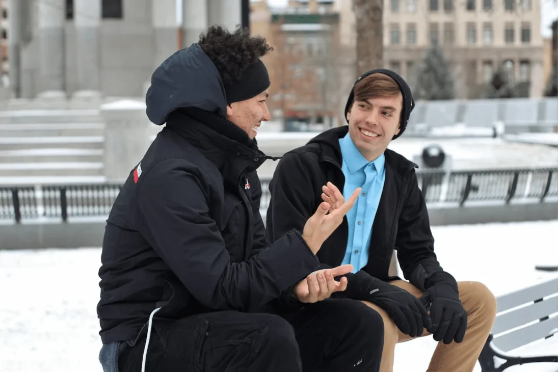 Two boys having a thoughtful conversation, symbolizing the balance between helpful and harmful uses of therapy speak.