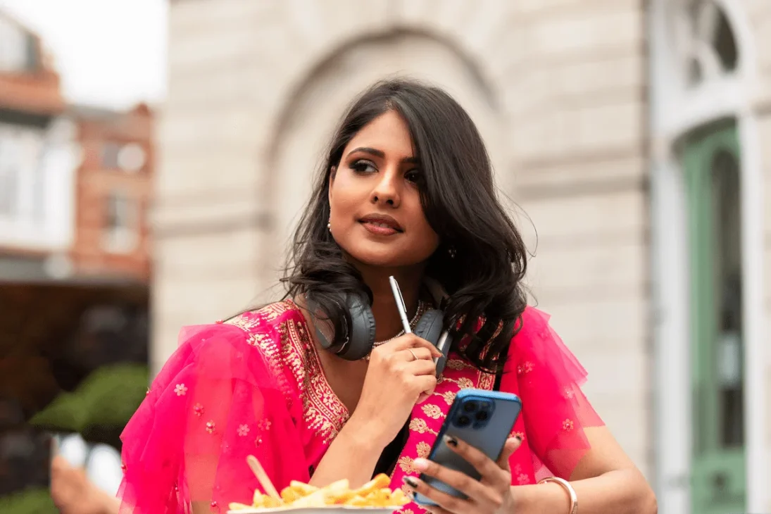 Indian woman in traditional dress using an iPhone