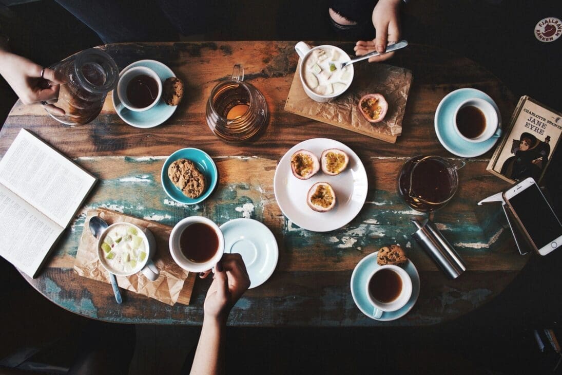 Café table setup with coffee and healthy snacks for a productive workday.