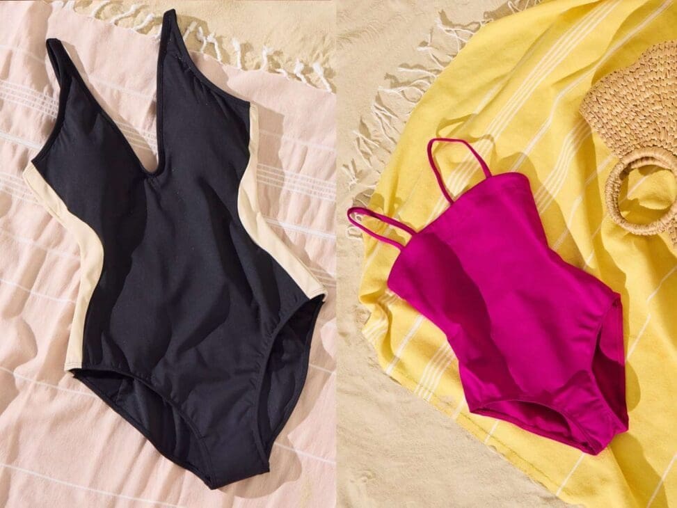 Close-up of swimsuits showcasing different fabrics and features, including chlorine-resistant, quick-dry, and UV-protective materials, laid out with sunglasses, a beach towel, and sunscreen for swimsuit guide.
